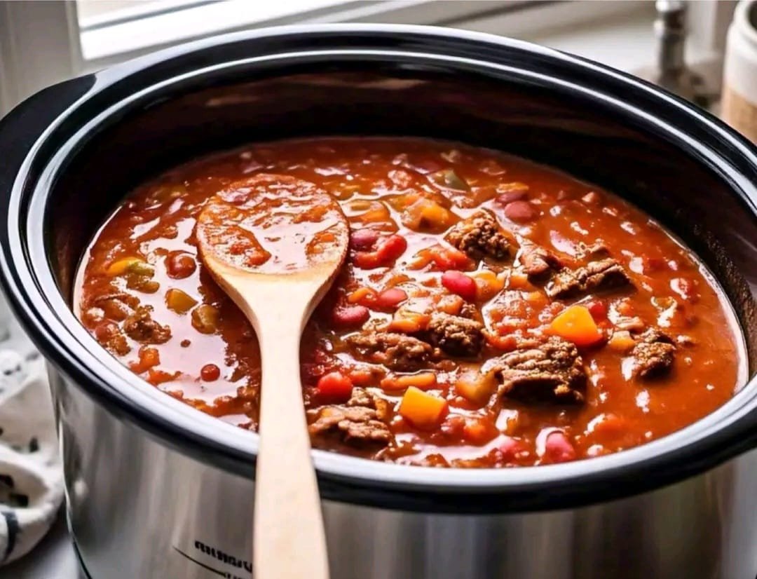 This hearty and flavorful crockpot chili is a perfect dish for a cozy meal. Slow cooking allows all the flavors to blend beautifully, creating a rich, thick, and delicious chili. Ingredients Protein: 1 pound ground beef or turkey (use lean ground meat for a healthier option) Vegetables & Beans: 1 medium sweet onion, diced (adds sweetness and depth) 3 cloves garlic, minced (for a bold, aromatic flavor) 1 yellow bell pepper, diced (adds a mild sweetness) 1 can kidney beans (15 oz), drained and rinsed 1 can red beans (15 oz), drained and rinsed 2 cans diced tomatoes (15 oz each), with their juices 1 can tomato paste (6 oz), for thickening 3 cups beef broth (can substitute with chicken or vegetable broth) Spices & Seasonings: 3 tablespoons chili powder (adjust to taste for heat preference) 1 tablespoon brown sugar (optional, helps balance acidity from tomatoes) 1 teaspoon cumin (adds a warm, earthy flavor) 1 teaspoon paprika (can use smoked paprika for a smoky kick) ¼ teaspoon chili flakes (optional, for extra heat) ½ teaspoon black pepper (freshly ground for best taste) Salt to taste Instructions Step 1: Brown the Meat Heat a large skillet over medium-high heat. Add the ground beef (or turkey) and cook, breaking it apart with a spatula. Continue cooking until browned and no longer pink (about 5-7 minutes). Step 2: Sauté the Aromatics Add the diced onion to the pan and cook until it becomes soft and translucent (about 3-5 minutes). Stir in the minced garlic and sauté for 1 minute, until fragrant. Step 3: Transfer to Crockpot Pour the browned meat, onions, and garlic into the crockpot. Step 4: Add Remaining Ingredients Add the diced tomatoes, tomato paste, beef broth, kidney beans, red beans, and diced bell pepper to the crockpot. Sprinkle in the chili powder, brown sugar (if using), cumin, paprika, chili flakes, and black pepper. Stir everything together until well combined. Step 5: Slow Cook the Chili Cover the crockpot with the lid and set: LOW for 8 hours (for the best flavor development) HIGH for 4 hours (if short on time) Step 6: Final Seasoning After cooking, taste and adjust salt as needed. Step 7: Serve & Enjoy. Ladle the chili into bowls and serve with your favorite toppings like: Shredded cheese (cheddar, Monterey Jack) Sour cream or Greek yogurt Chopped green onions Crushed tortilla chips Jalapeño slices Storage & Reheating Tips Refrigeration: Store leftovers in an airtight container for up to 4 days. Freezing: Chili freezes well for up to 3 months. Thaw overnight in the fridge before reheating. Reheating: Warm on the stove over low heat or in the microwave in short bursts, stirring in between. Enjoy your rich, slow-cooked chili.